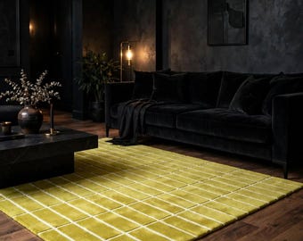 May include: A rectangular area rug featuring a vibrant chartreuse green base with a repeating grid pattern of thin, white horizontal and vertical lines. The rug has a soft, plush texture and is laid flat on a dark brown wooden floor surface.