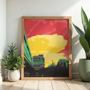 Peut inclure: Une affiche encadrée représentant une ville stylisée avec une palette de couleurs vives. L'œuvre d'art présente des bâtiments gris et verts sur fond de ciels rouges et jaunes. L'impression est présentée sur un sol en bois.
