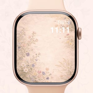 Può includere: Uno smartwatch color oro rosa con un design floreale sullo schermo. Lo schermo mostra l'ora 11:11 e la data venerdì 13. Il cinturino dell'orologio è di colore rosa chiaro.
