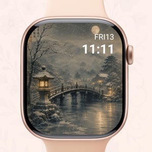 May include: A rose gold smartwatch with a rectangular display showing a digital clock face with the time 11:11 and the date FRI13. The screen features a snowy landscape illustration with a stone lantern, a bridge, and a full moon.
