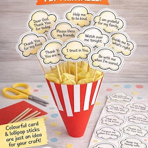 May include: A PDF printable featuring prayer prompts for children. The image displays cloud-shaped cards with phrases such as "Thank You for my food" and "I trust in You." The cards are on sticks in a red and white striped cone.