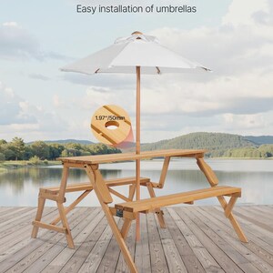 May include: A wooden picnic table with two attached benches and a central hole for an umbrella. The hole measures 1.97 inches in diameter. The table features a light wood finish and a folding design. Text on the image reads Built-in Umbrella Hole.