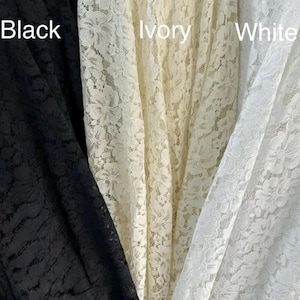 May include: Three vertical panels of floral lace fabric displayed side by side. The left panel is black, the center panel is ivory, and the right panel is white. The text Black, Ivory, and White is printed over each respective fabric color.