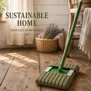 May include: A green mop with a textured, olive-colored crocheted cover on the rectangular head. The text SUSTAINABLE HOME INSTANT DOWNLOAD is visible in the upper left corner. The mop rests on a wooden floor near a woven basket and a chair.