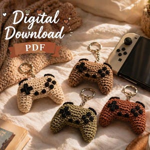 May include: Four crochet controller keychains in beige, green, and brown with black button details. The keychains are displayed with a game console and the text "Digital Download PDF".