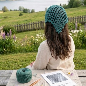 May include: A person wearing a teal crochet hat, sitting outdoors with a ball of teal yarn, crochet hook, scissors, and a pattern. The pattern reads "Instant PDF Download Pattern". The background features a lake and green landscape.
