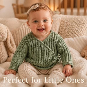 May include: A baby wearing a sage green knit wrap sweater and beige pants smiles at the camera. A stuffed bunny and teddy bear are on either side of the baby. The text "Perfect for Little Ones" is at the bottom of the image.