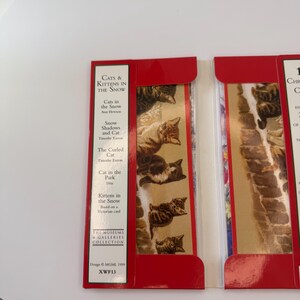 May include: A set of bookmarks titled Cats & Kittens in the Snow featuring illustrations of various cats in snowy settings. The packaging includes the text Cats in the Snow, Snow Shadows and Cat, The Curled Cat, Cat in the Park, and Kittens in the Snow.