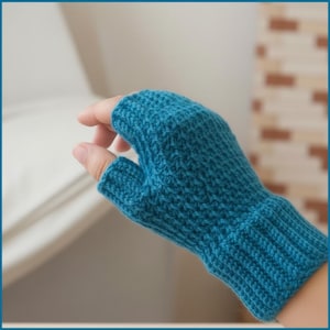 May include: A teal blue, fingerless knitted glove. The glove is made of a textured yarn and features a ribbed cuff. The thumb is separated, and the glove covers the hand up to the knuckles.