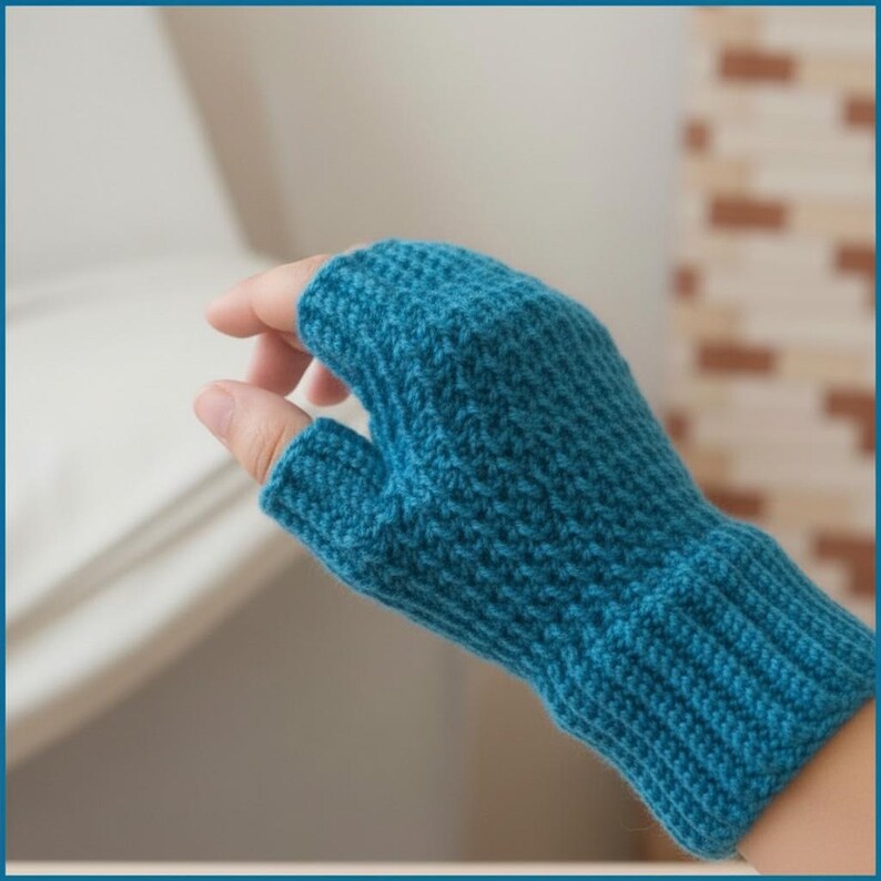 May include: A teal blue, fingerless knitted glove. The glove is made of a textured yarn and features a ribbed cuff. The thumb is separated, and the glove covers the hand up to the knuckles.