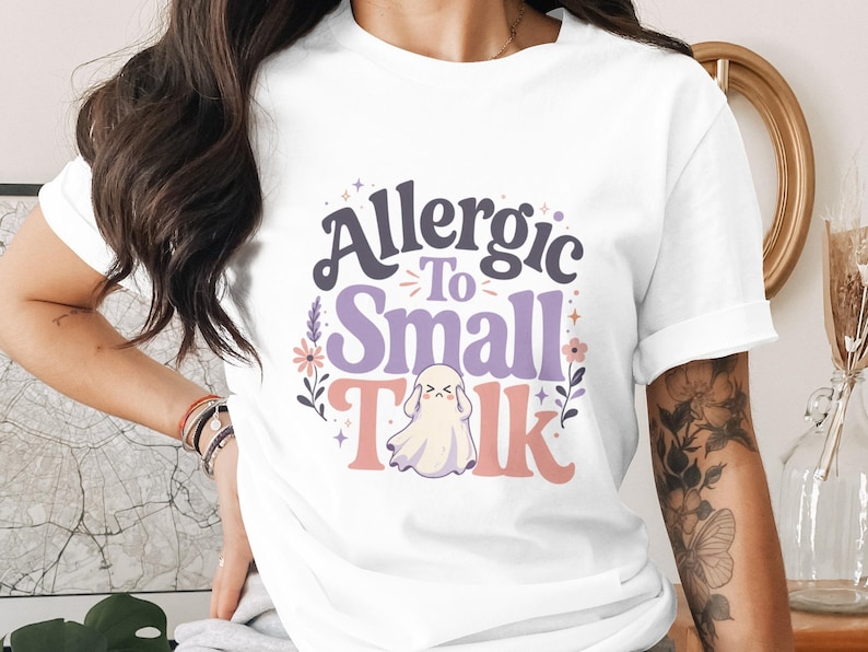 T-shirt with text "Allergic To Small Talk" and a ghost graphic.