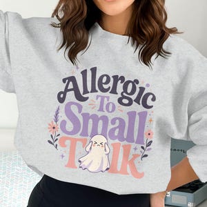 Gray sweatshirt with "Allergic To Small Talk" and a ghost graphic.
