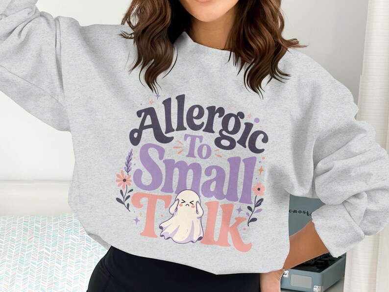 Gray sweatshirt with "Allergic To Small Talk" and a ghost graphic.