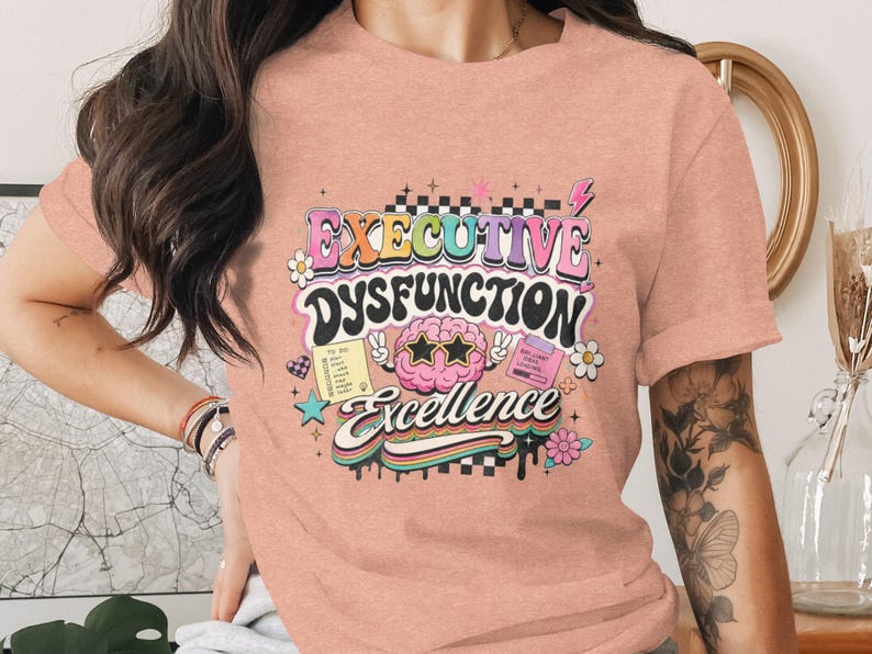 T-shirt with "Executive Dysfunction Excellence" in retro font and illustrations.