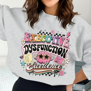 Grey sweatshirt with "EXECUTIVE DYSFUNCTION Excellence" text and to-do list.