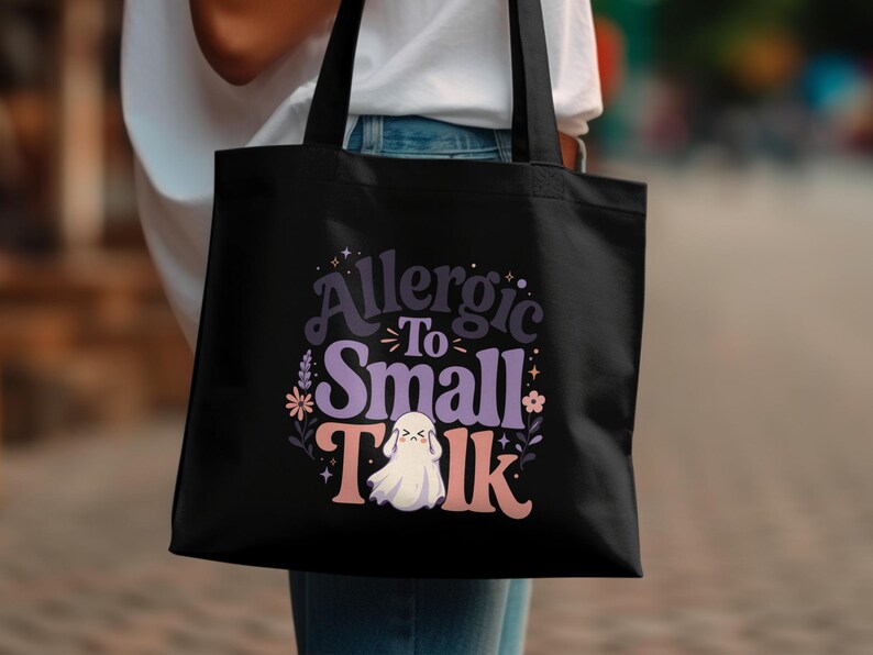 Black tote bag with "Allergic To Small Talk" text and a ghost graphic.