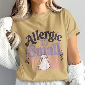 T-shirt with "Allergic to Small Talk" text and ghost graphic.