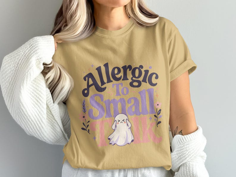 T-shirt with "Allergic to Small Talk" text and ghost graphic.
