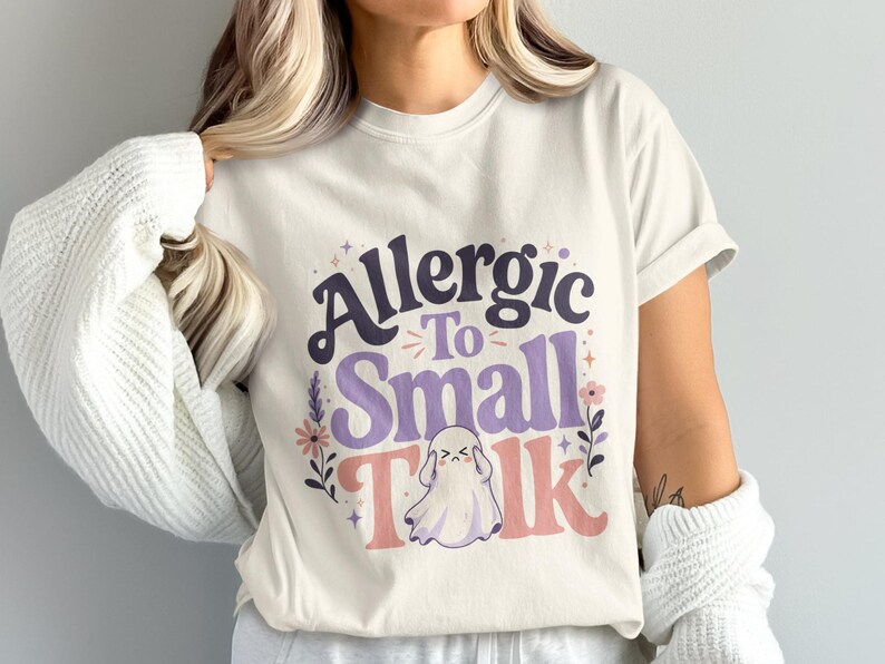 Cream t-shirt with "Allergic To Small Talk" text and ghost graphic.