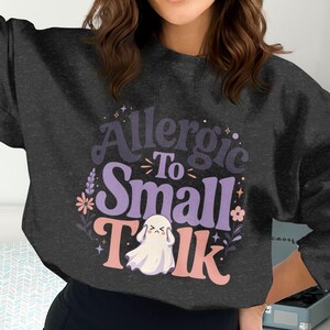 Black crewneck sweatshirt with "Allergic To Small Talk" and ghost graphic.