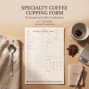 May include: A printed coffee cupping form with sections for sensory notes and flavor evaluation, accompanied by a silver spoon, a small bowl of coffee beans, a digital scale, and a notebook labeled Cupping Notebook on a wooden surface.