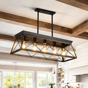 May include: A rectangular, black and bronze-colored chandelier with five exposed light bulbs. The fixture has a geometric design with a black top and a bronze-colored frame. The light bulbs are Edison-style.