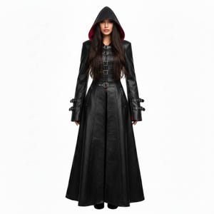 May include: A long black hooded coat with a red lining. The coat has multiple buckles and straps on the sleeves and front. The coat features a long, flowing skirt and is made of a leather-like material.