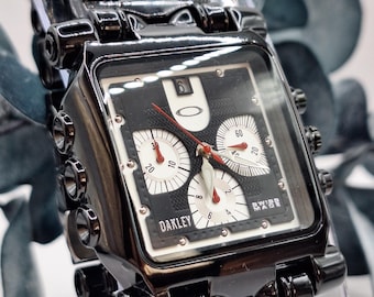 Minute Machine-style Oakley chronograph with a square case in black steel, a bold symbol of the era