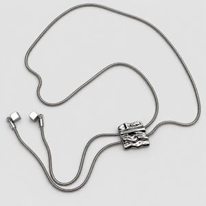 Full product view of a silver tone bolo tie lariat necklace arranged on a clean light background. The long continuous snake chain loops around the sculptural wavy slider and extends into two tassel ends with polished square charms. Clear flat lay shows the adjustable Y necklace construction, statement slider and elegant long necklace proportions for modern everyday styling.