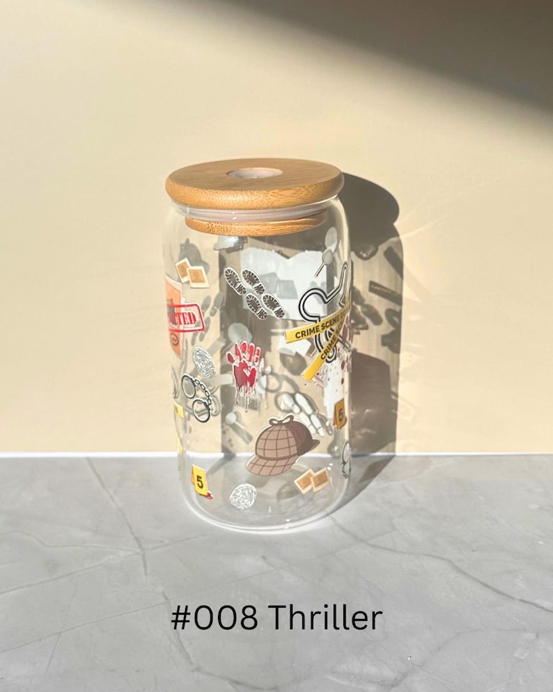 May include: A clear glass tumbler with a wooden lid, decorated with crime scene-themed graphics. The design includes a handprint, footprints, and a detective hat. The text "#008 Thriller" is at the bottom.