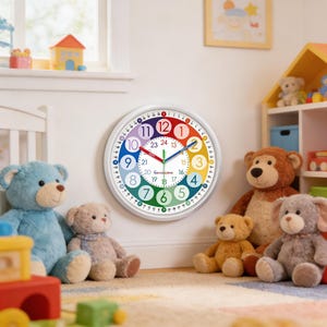 May include: A colorful wall clock with a white frame, featuring a rainbow-colored face with numbers and hands. The clock is surrounded by several teddy bears of various colors, creating a playful nursery setting.