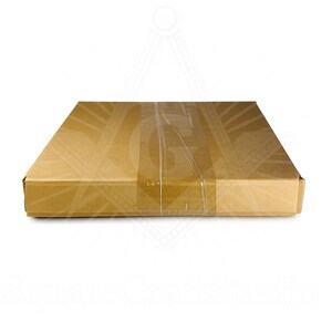 May include: A rectangular cardboard box, sealed with clear packing tape. The box is a light brown color and appears to be empty. The words "SquareCraftStudio" are visible at the bottom of the image.