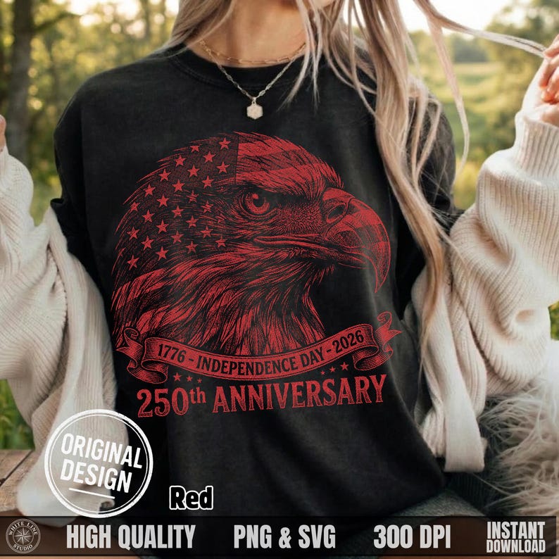 Close up of a woman wearing a dark grey t-shirt featuring the red halftone American eagle 1776 to 2026 design