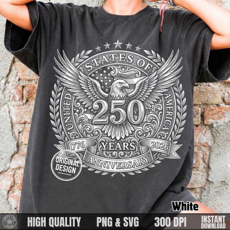 Woman leaning against a brick wall wearing a dark grey t-shirt with a white vintage halftone 250 years anniversary bald eagle design.