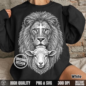 May include: Black sweatshirt featuring a detailed white graphic of a lion's head with a cross on its forehead, above a sheep's head. The design includes the text "ORIGINAL DESIGN", "HIGH QUALITY", "PNG & SVG", "300 DPI", "White", and "INSTANT DOWNLOAD".
