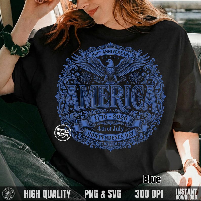 Woman sitting in a car wearing a black t-shirt featuring a blue hand-drawn America 250th Independence Day eagle design.