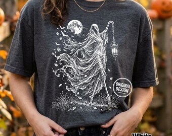 Może przedstawiać: Ciemnoszary melanżowy t-shirt z białą grafiką przedstawiającą szkieletową postać w pelerynie trzymającą latarnię. Wzór zawiera pełnię księżyca, latające nietoperze i opadające liście. Okrągła naszywka na koszulce zawiera napis ORIGINAL DESIGN.