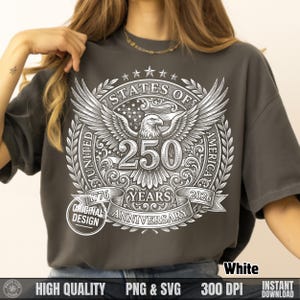 Woman wearing a dark grey t-shirt with a white vintage halftone United States of America 250 years anniversary bald eagle graphic.