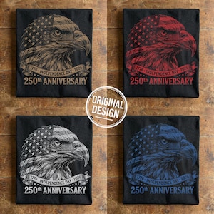 Four folded black t-shirts displaying the vintage eagle USA design in beige, red, white, and blue colors