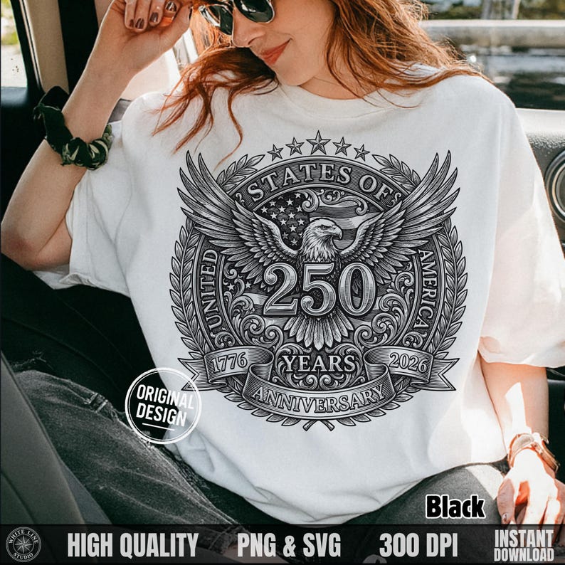 Woman in a car wearing a white t-shirt featuring a black line art vintage 250 years anniversary bald eagle graphic.