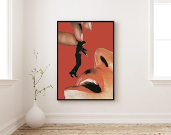 May include: A framed art print featuring a surrealist collage. A black silhouette of a person is suspended in mid-air, held by a finger, against a red background. A large mouth is open below. The artwork is displayed in a white room.