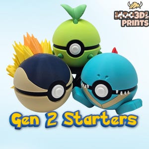 May include: Three colourful, stylised figures resembling Pok&eacute;mon characters. One is green with a leaf, another is blue, and the third is navy and tan. The text "Gen 2 Starters" is displayed below the figures. The logo "MOOD3D PRINTS" is in the upper right.