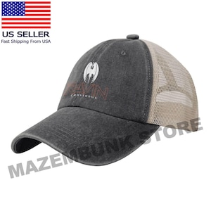 May include: A gray baseball cap with a curved brim and a tan mesh back. The cap features the text "RAVIN CROSSBOWS" in a stylized font, along with a white emblem. The cap is a US Seller.