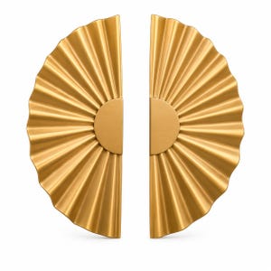 May include: Two gold-colored, fan-shaped cabinet pulls. Each pull has a half-circle center and a radiating, ridged design. The hardware is made of metal and is designed for use on cabinets or drawers. The pulls are shown against a white background.