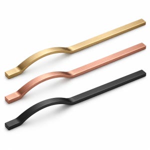 May include: Three elongated cabinet pulls arranged diagonally, featuring a distinct wave-like curve. The top pull is brushed gold, the middle is rose gold, and the bottom is matte black. Each handle has a rectangular profile and a smooth finish.