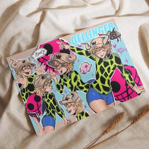 May include: A colorful art print featuring multiple illustrations of a character in a green and black patterned top, blue shorts, and a hat. The print has the word "Dellinger" at the top and includes the artist's signature.