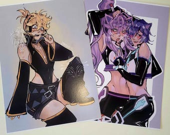 May include: Two art prints featuring anime-style illustrations. One print depicts a character in a black outfit with gold accents, and the other shows two characters with purple and blue hair in black and white outfits.