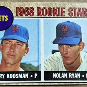 May include: A vintage baseball card featuring two players in blue Mets caps. The card reads "1968 ROOKIE STARS" at the top, with the Mets logo and player names "JERRY KOOSMAN" and "NOLAN RYAN" below. The card has a cream-colored border.