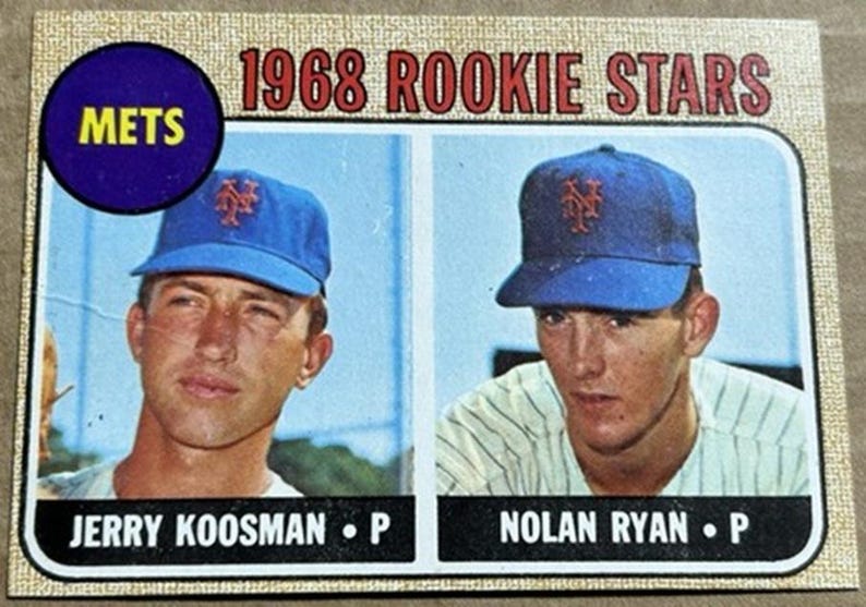 May include: A vintage baseball card featuring two players in blue Mets caps. The card reads "1968 ROOKIE STARS" at the top, with the Mets logo and player names "JERRY KOOSMAN" and "NOLAN RYAN" below. The card has a cream-colored border.