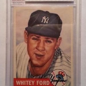 May include: A 1953 Topps baseball card of Whitey Ford, graded VG-EX 4 by BVG. The card features a portrait of Ford in a New York Yankees cap and uniform. The Yankees logo is visible. The card is encased in a protective holder.